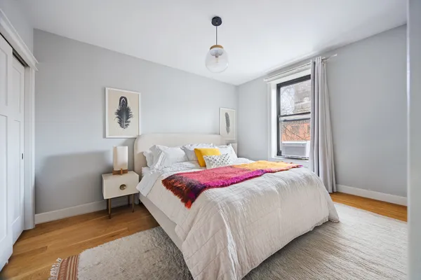 a bedroom with bed and window