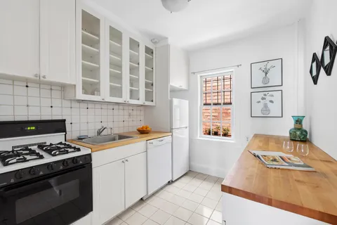 a kitchen with stainless steel appliances a stove a sink and a microwave