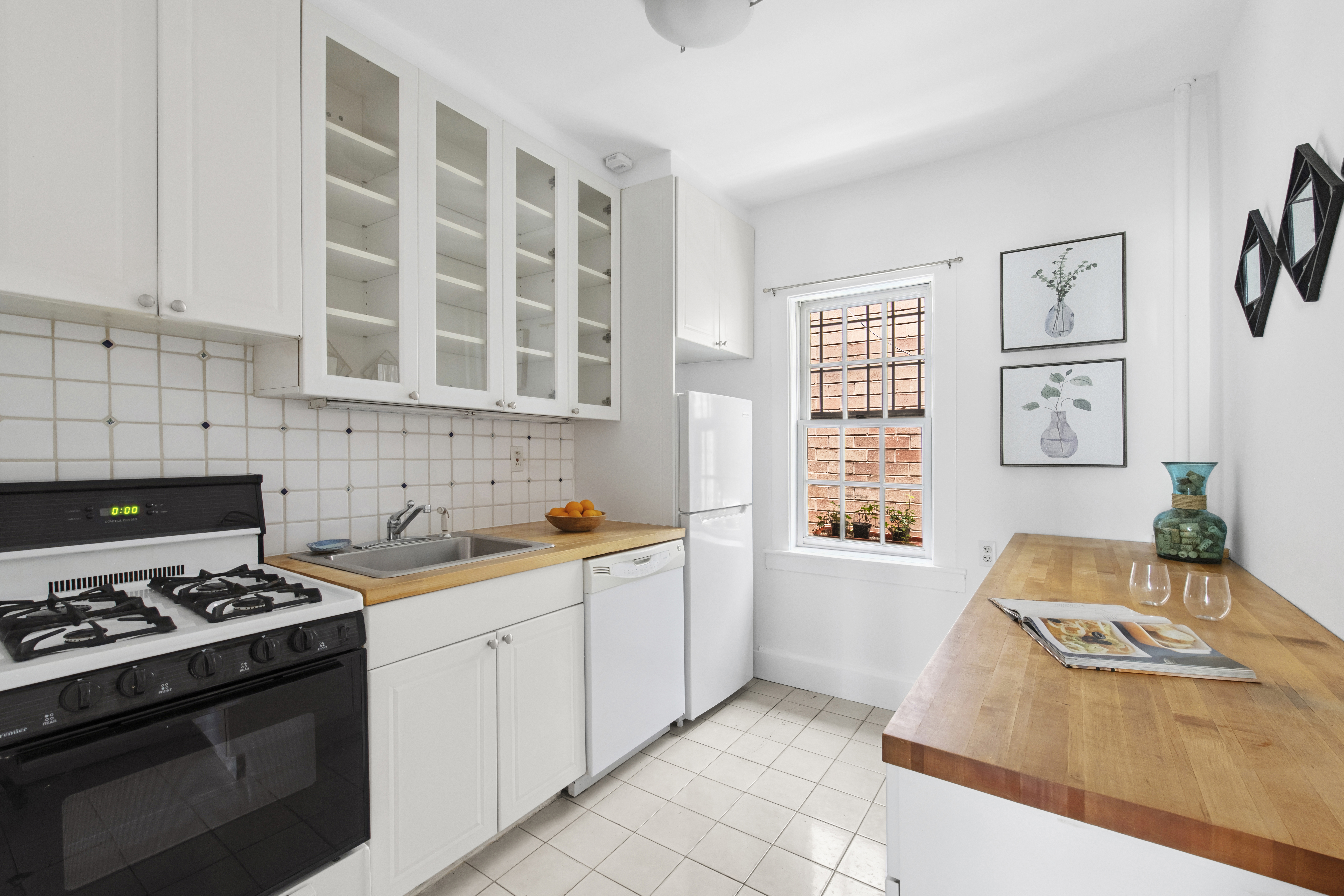 10 Pomander Walk, Unit 1 Manhattan, NY 10025 - Photo 5 of 13 a kitchen with stainless steel appliances a stove a sink and a microwave