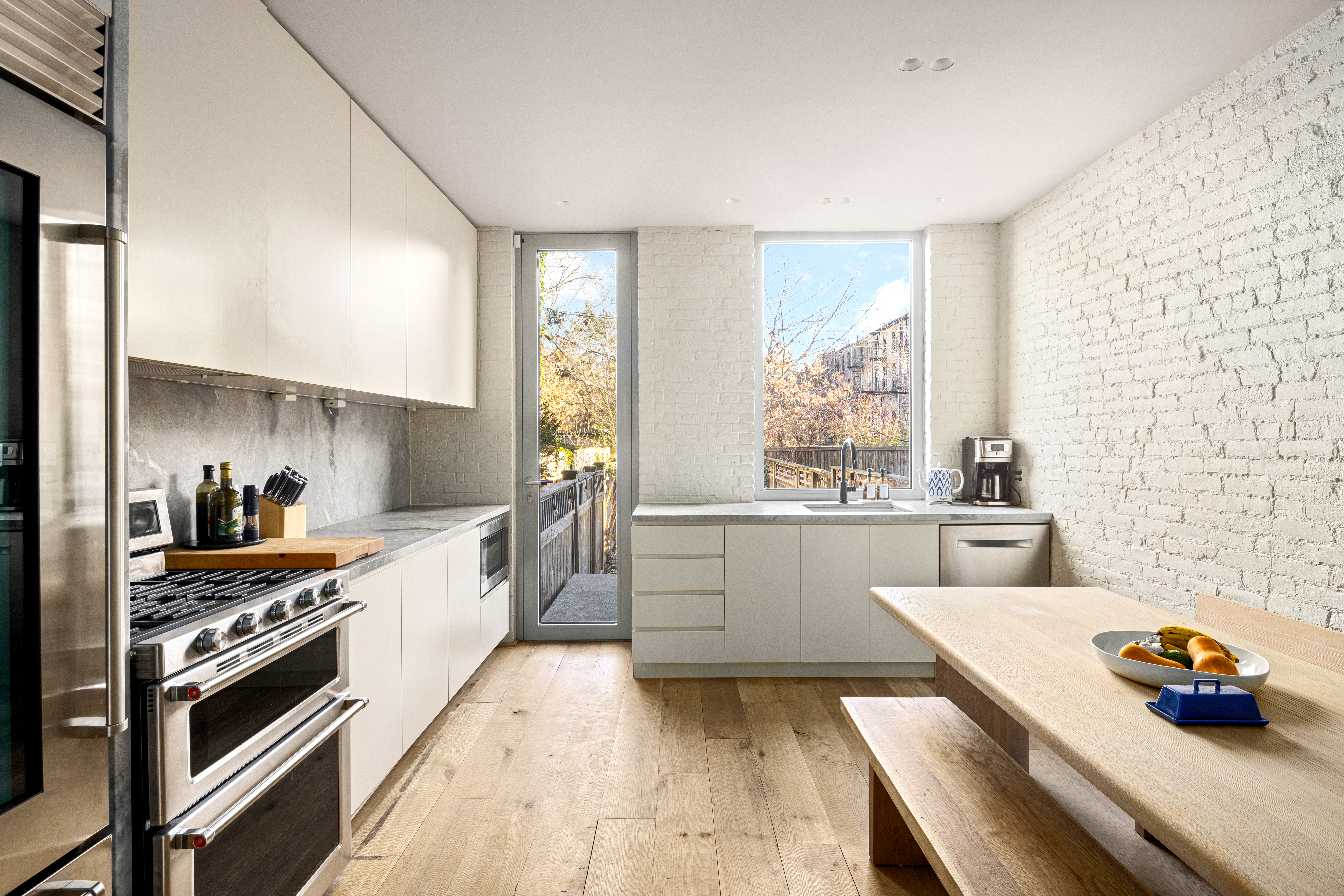 159 Hoyt Street Brooklyn, NY 11217 - Photo 3 of 18 a kitchen with stainless steel appliances a stove a sink and white cabinets