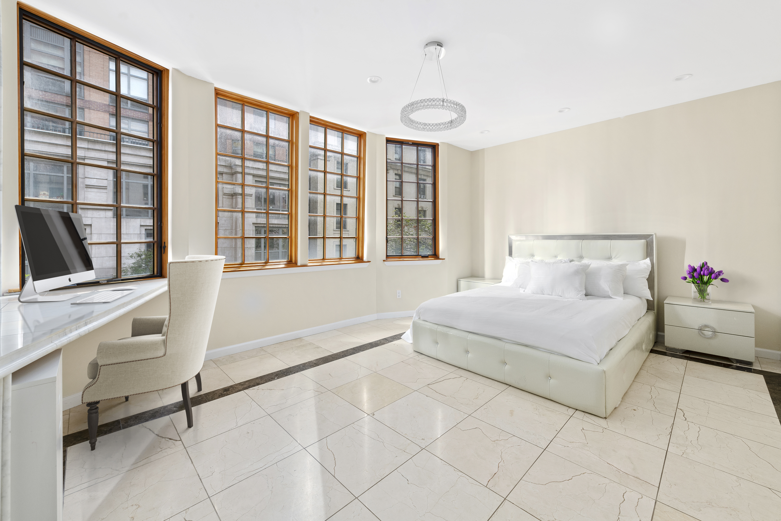 195 East 76th Street Manhattan, NY 10021 - Photo 14 of 20 a spacious bedroom with a large bed and a window