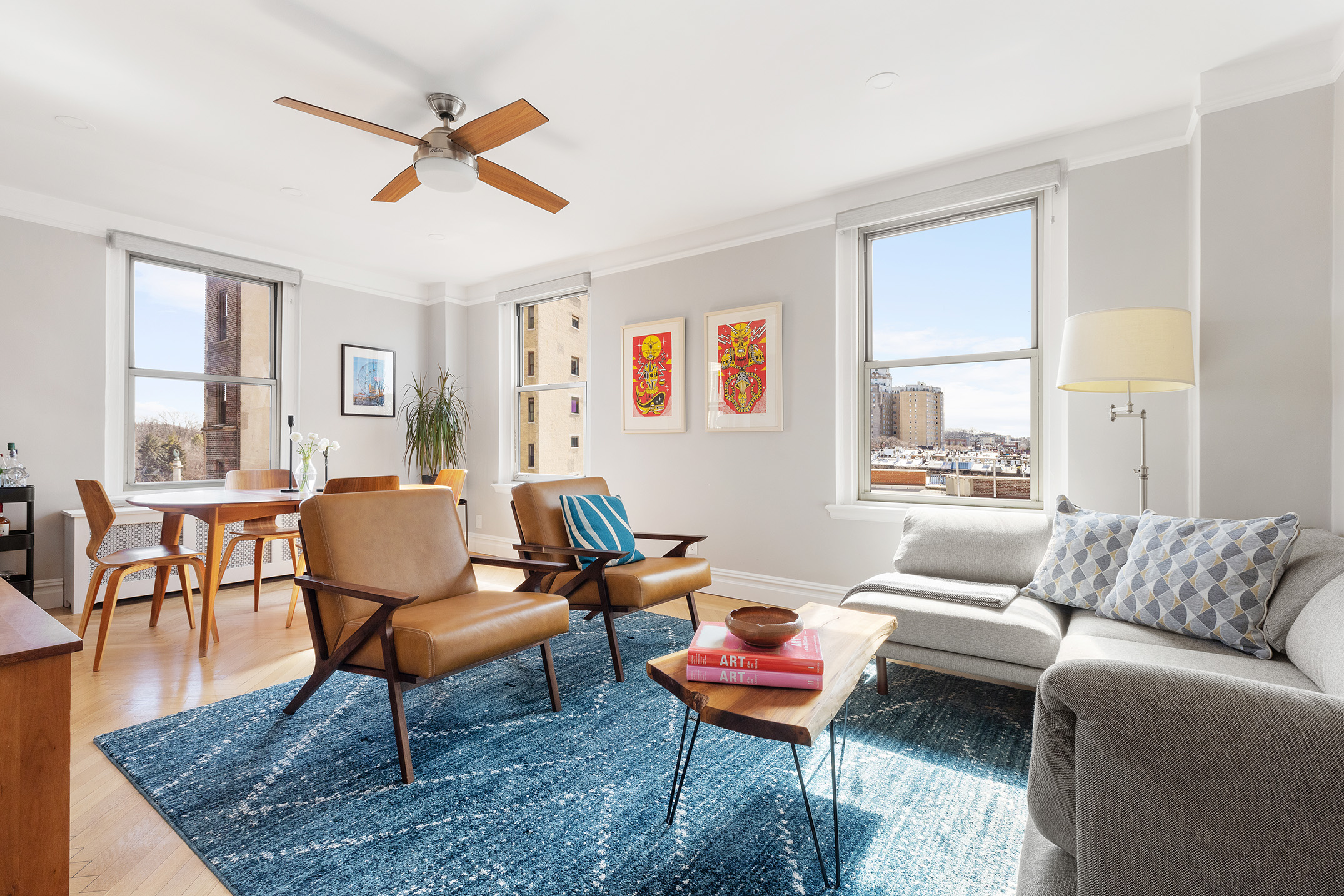 a living room with furniture kitchen view and a window
