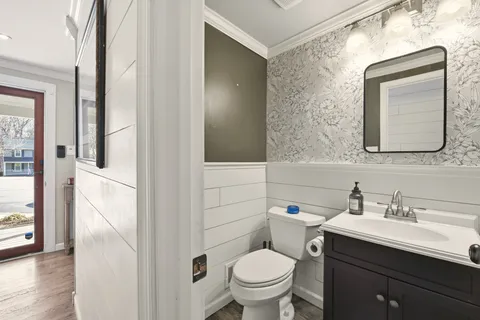 a bathroom with a toilet sink and mirror
