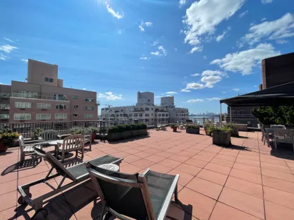 a view of a terrace with furniture and a fire pit