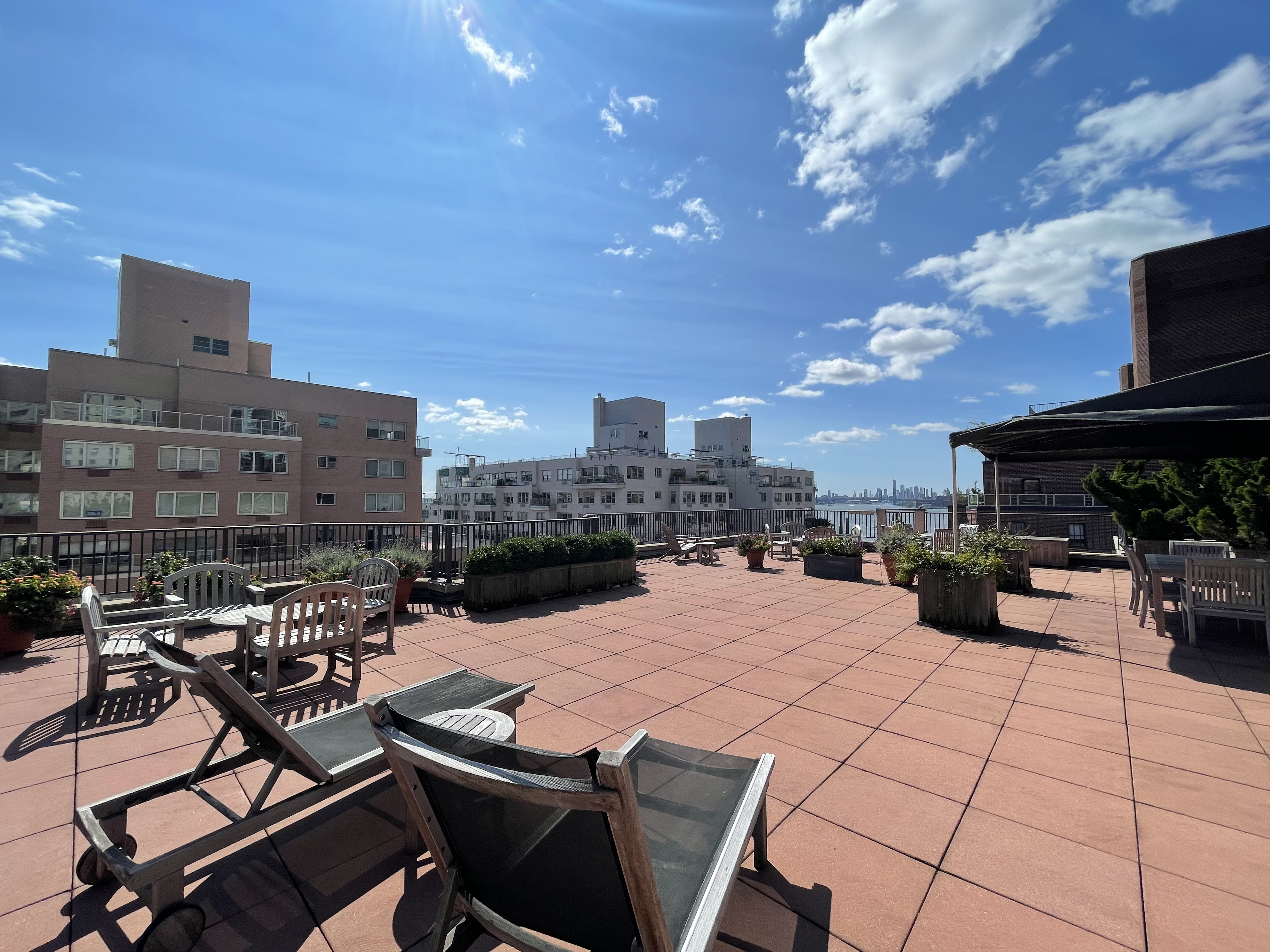 36 Sutton Place South, Unit 11D Manhattan, NY 10022 - Photo 9 of 11 a view of a terrace with furniture and a fire pit
