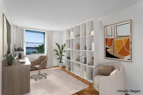 a living room with furniture a rug and a window