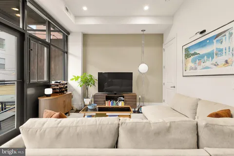 a living room with furniture and a flat screen tv