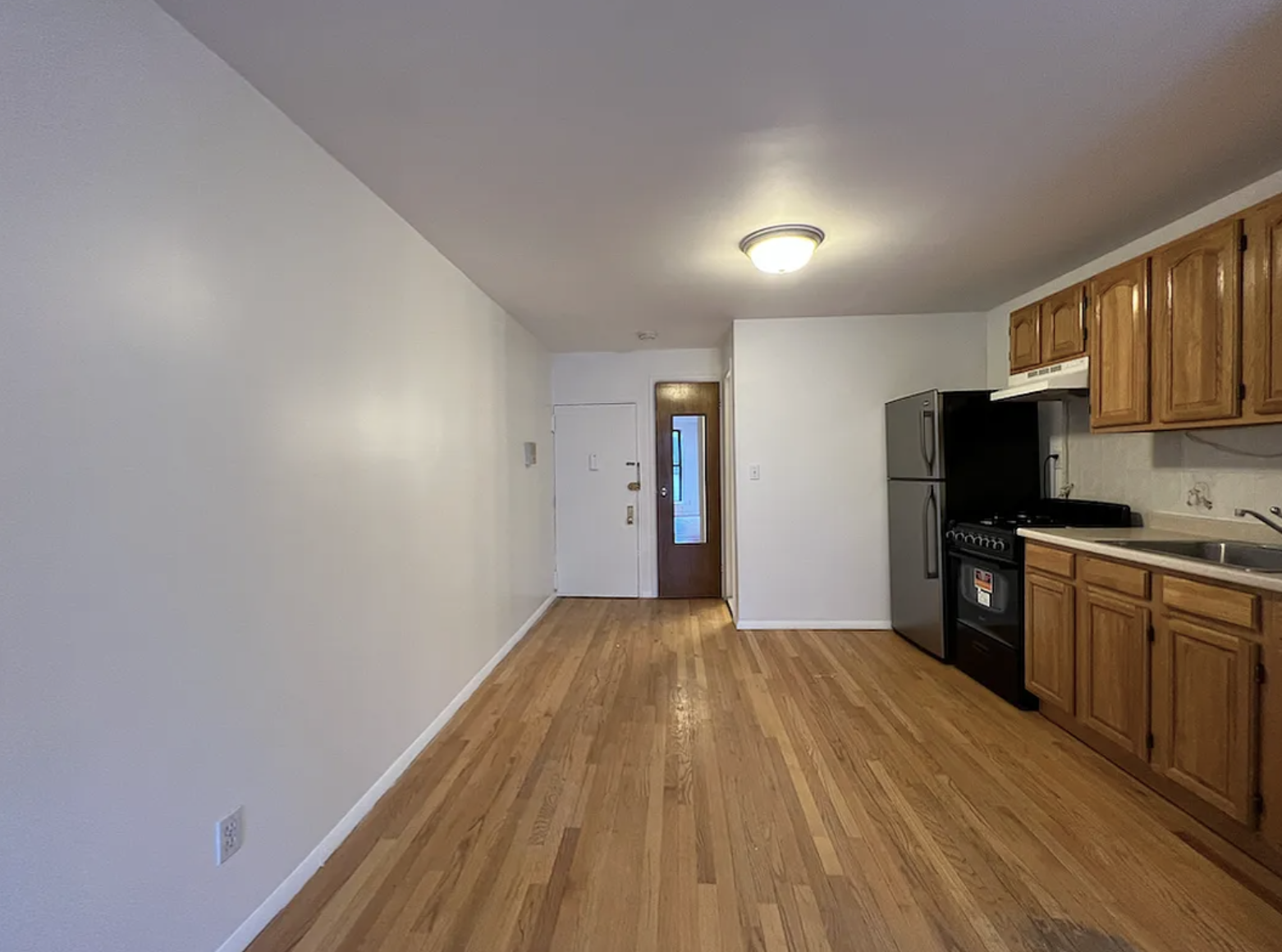 446 West 46th Street, Unit 12 Manhattan, NY 10036 - Photo 9 of 18 a kitchen with a refrigerator and a stove top oven