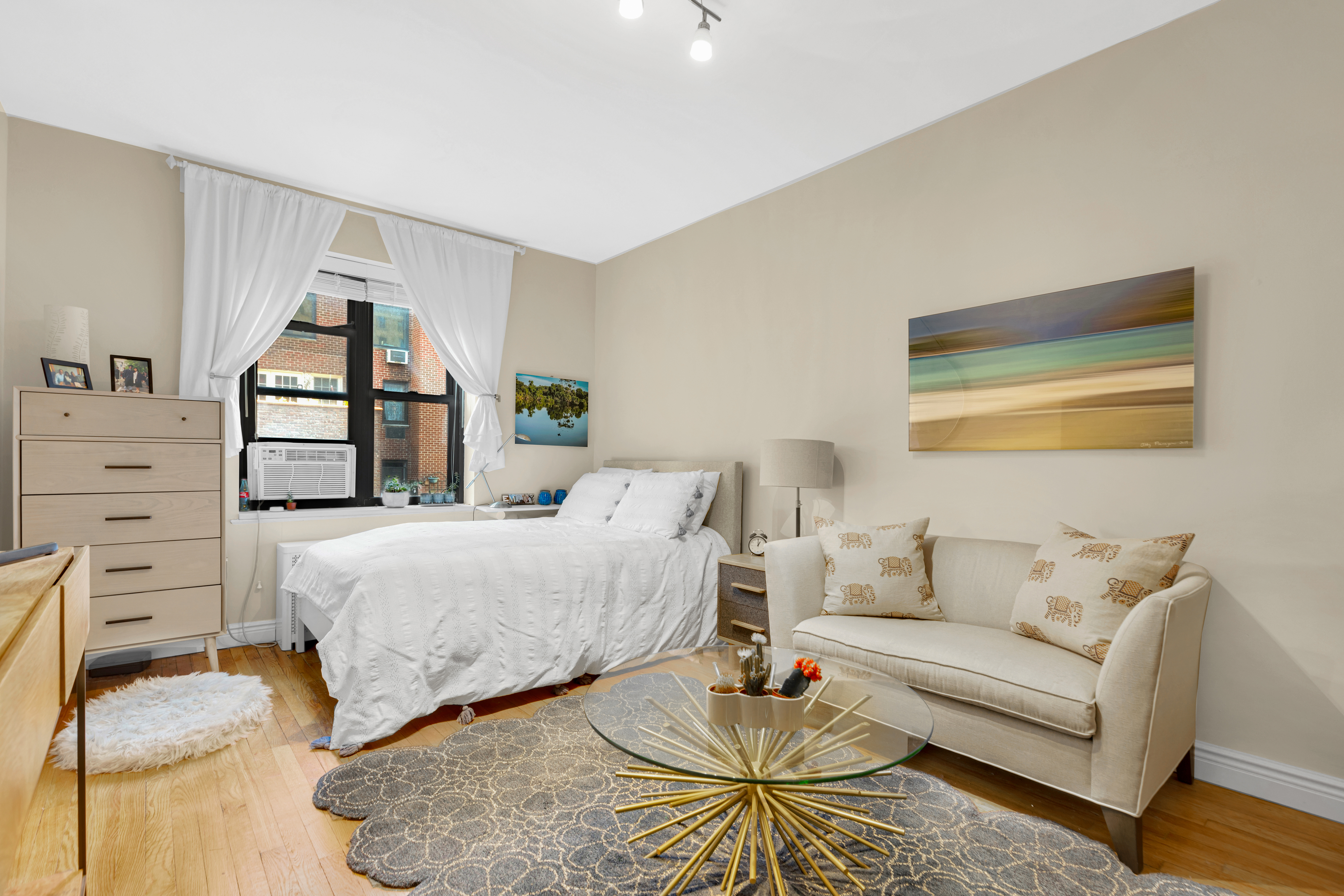 312 West 23rd Street, Unit 3R Manhattan, NY 10011 - Photo 3 of 6 a bedroom with a bed couches and a dresser
