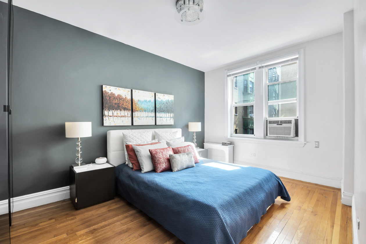 720 West 173rd Street, Unit 38 Manhattan, NY 10032 - Photo 6 of 9 a bedroom with a large bed and a large window