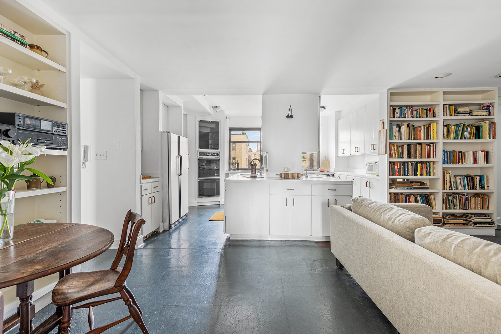 110-118 Riverside Drive, Unit 15A Manhattan, NY 10024 - Photo 6 of 17 a living room with furniture and a book shelf