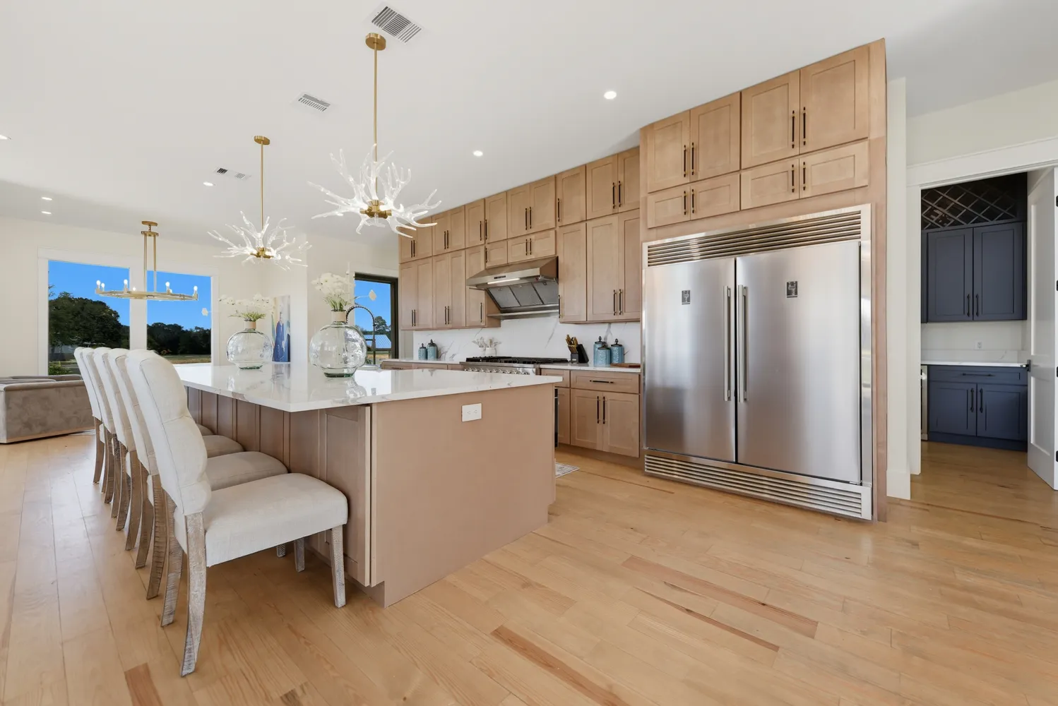 a kitchen with stainless steel appliances kitchen island granite countertop a refrigerator a sink and a stove