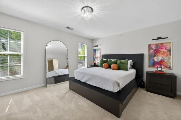 a bed sitting in a bedroom next to a window