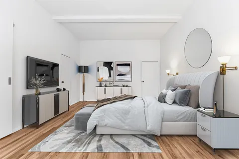 a bedroom with a bed and flat screen tv