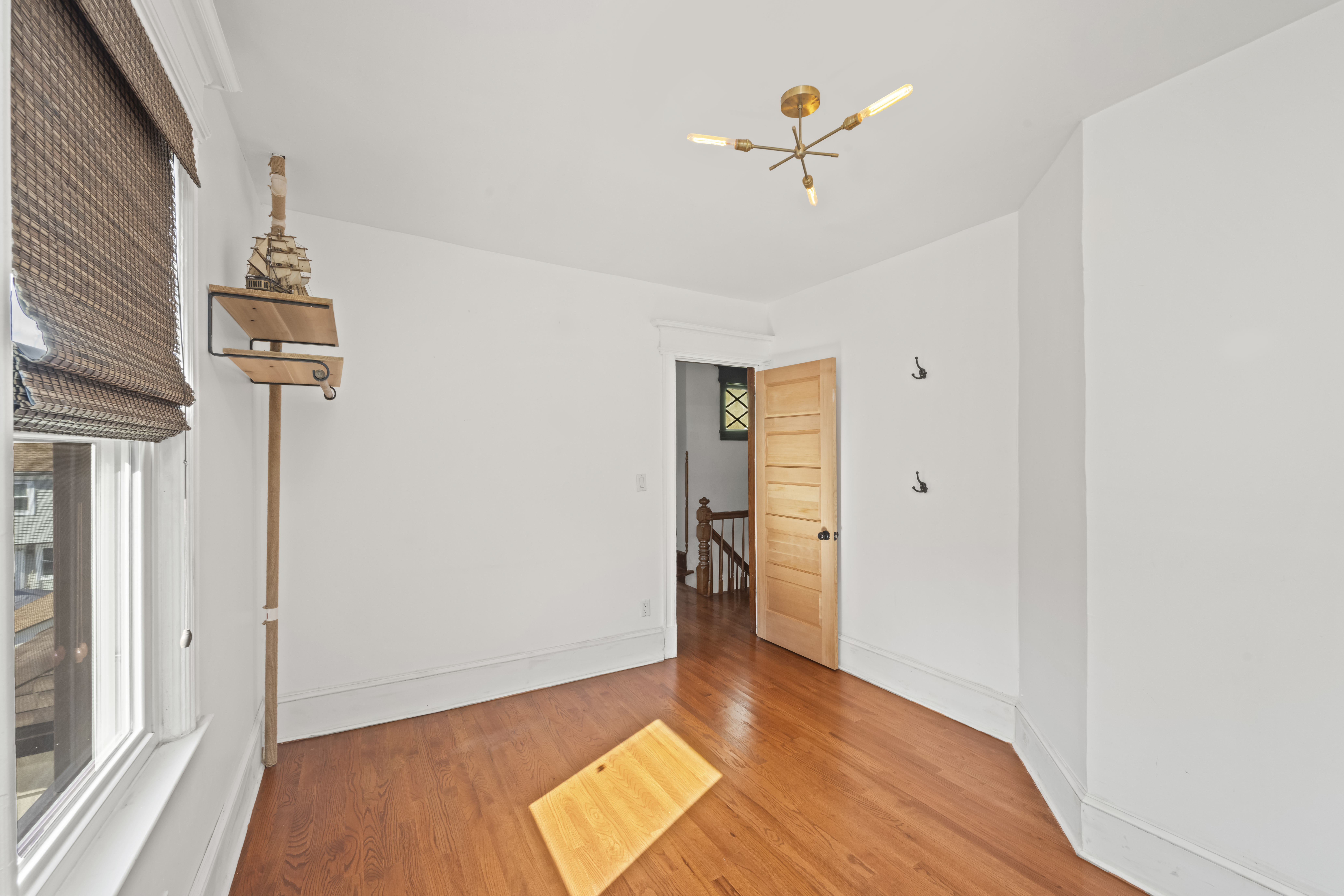 704 Delafield Avenue Staten Island, NY 10310 - Photo 17 of 35 a view of a livingroom with wooden floor and a ceiling fan
