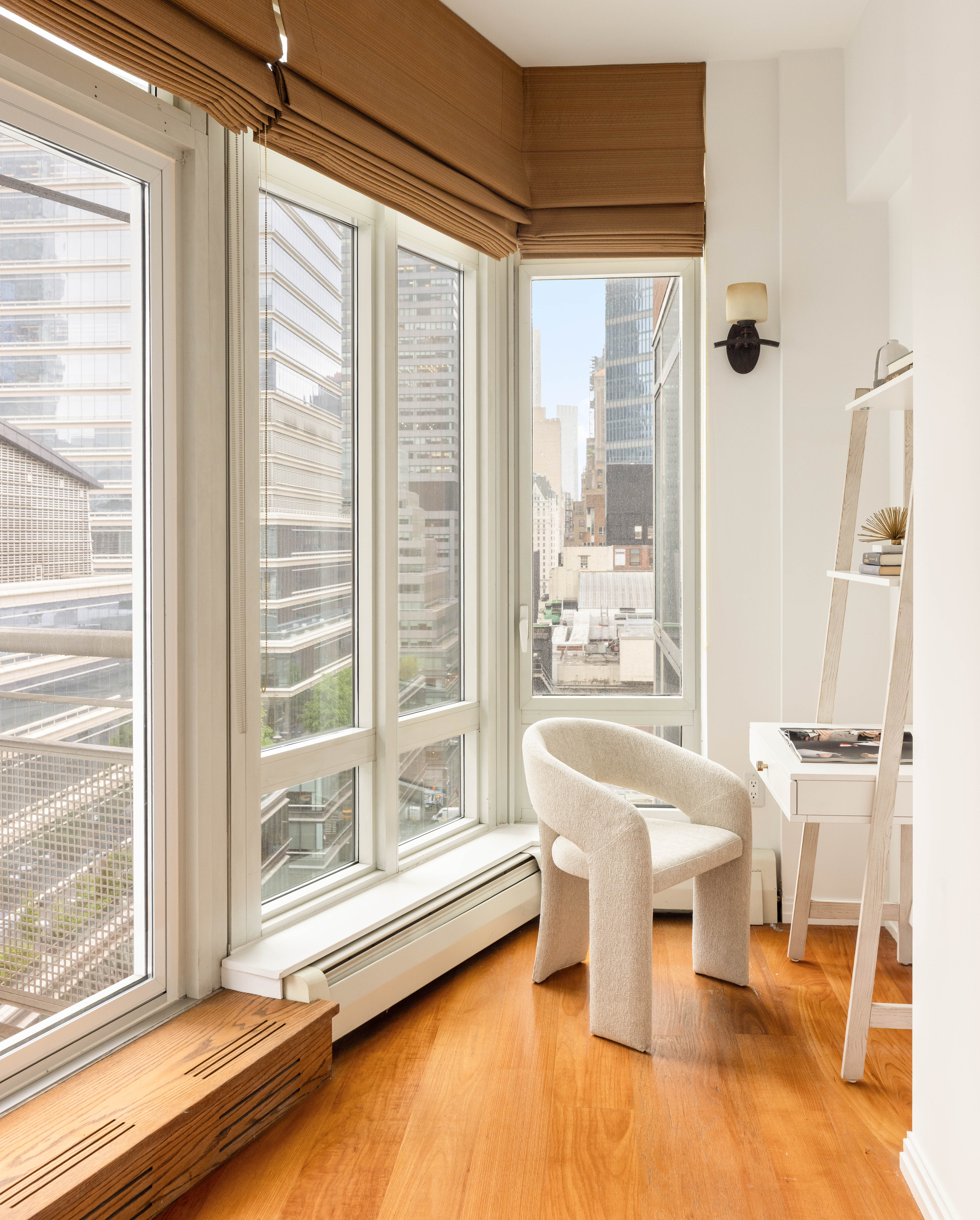205 East 59th Street, Unit 14B Manhattan, NY 10022 - Photo 11 of 19 a living room with a large window and furniture