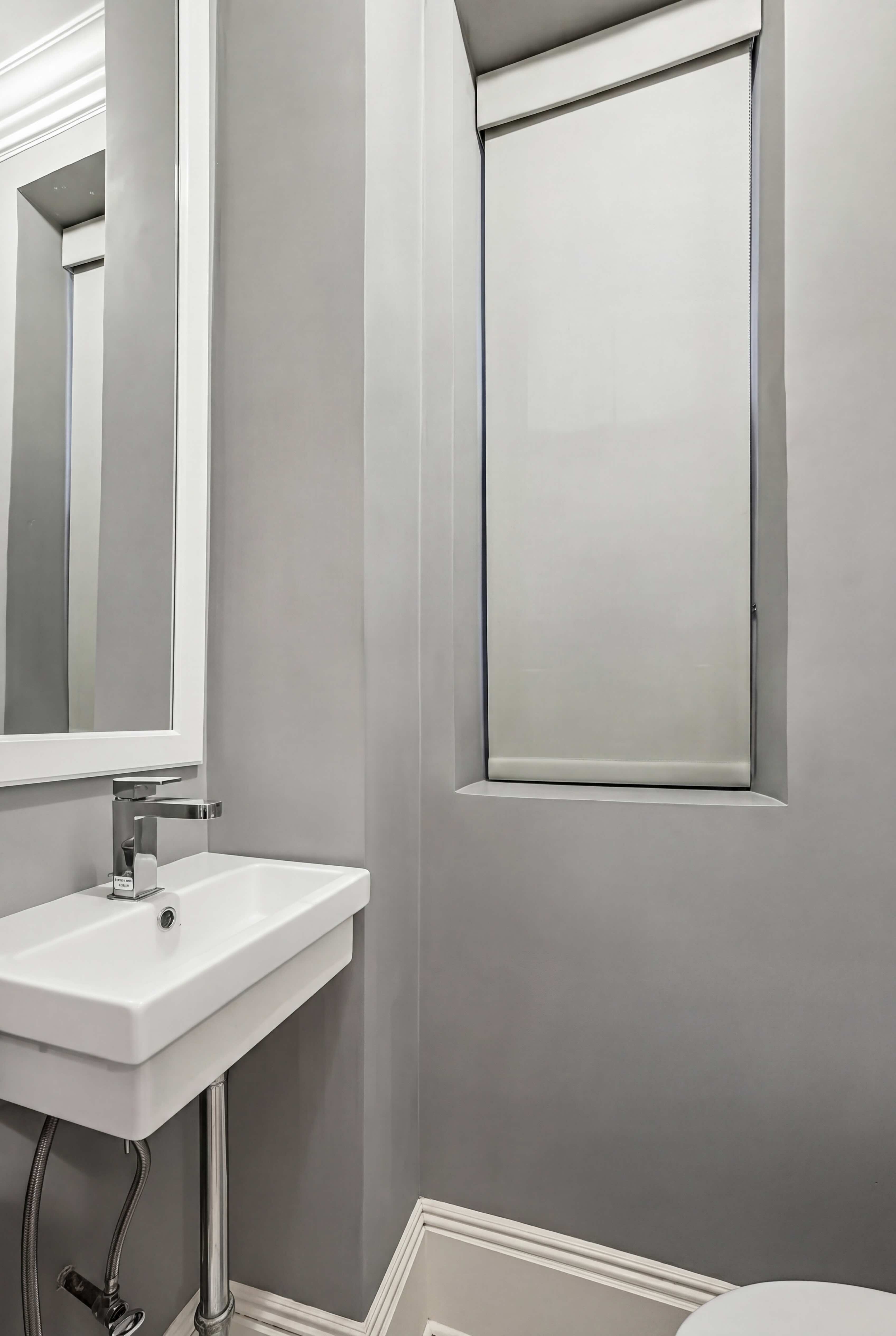 77 Park Avenue, Unit 6H Manhattan, NY 10016 - Photo 7 of 9 a bathroom with a sink and a mirror