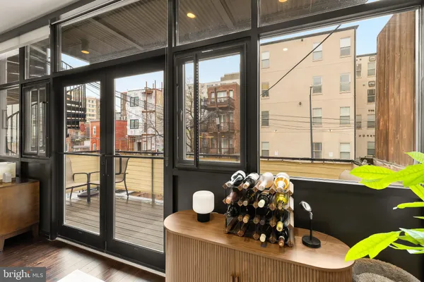 a room with a large window and furniture