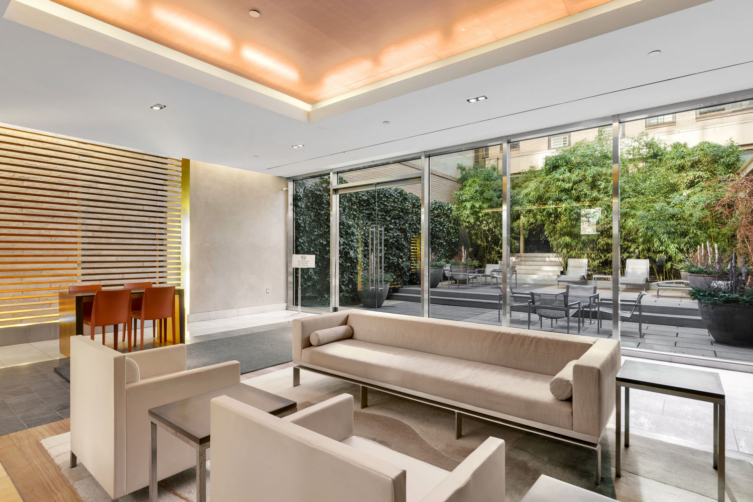 300 East 55th Street, Unit 28B Manhattan, NY 10022 - Photo 9 of 12 a living room with furniture and a large window