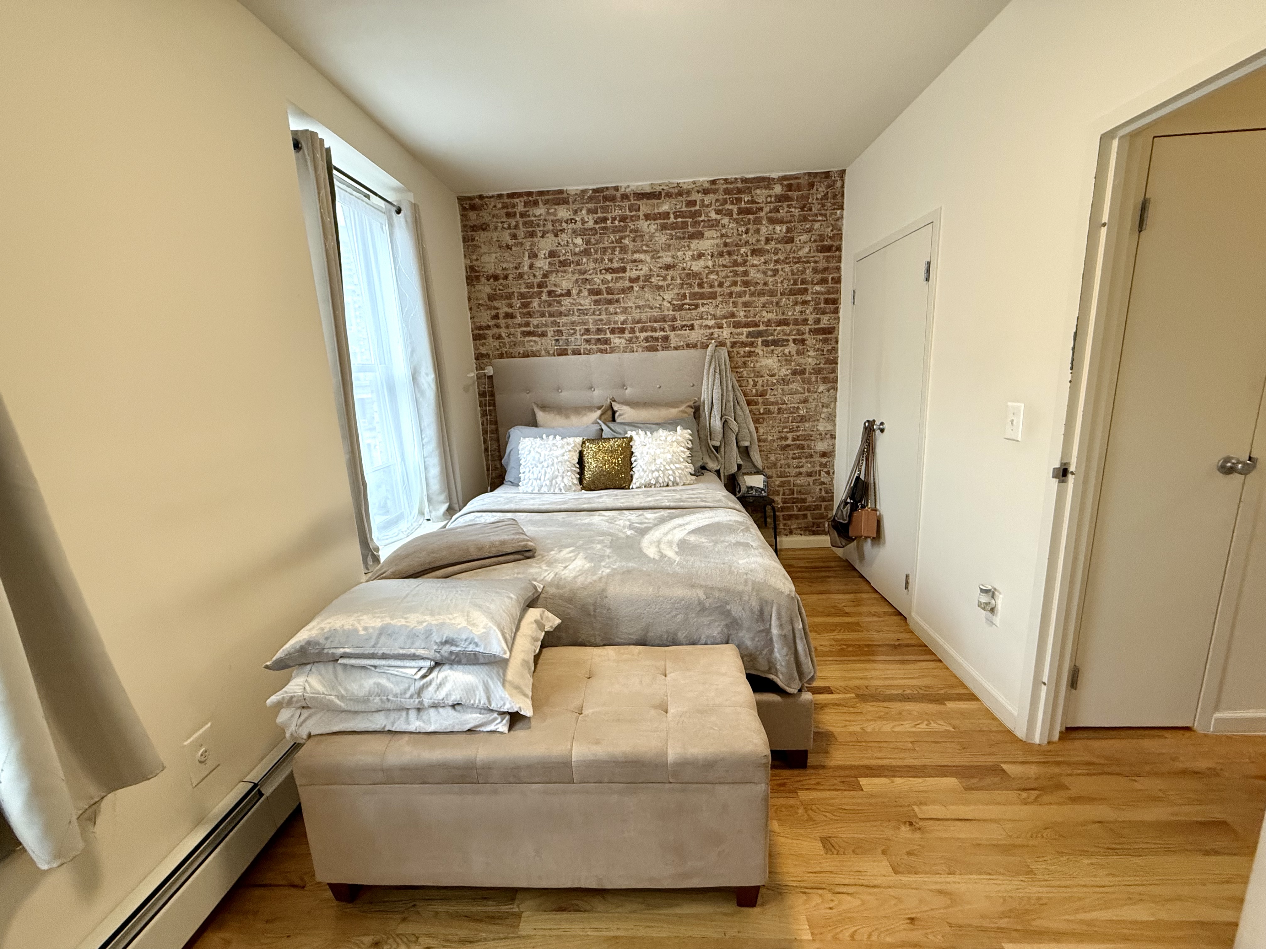 Convent Avenue Manhattan, NY 10031 - Photo 7 of 12 a bedroom with a bed and wooden floor