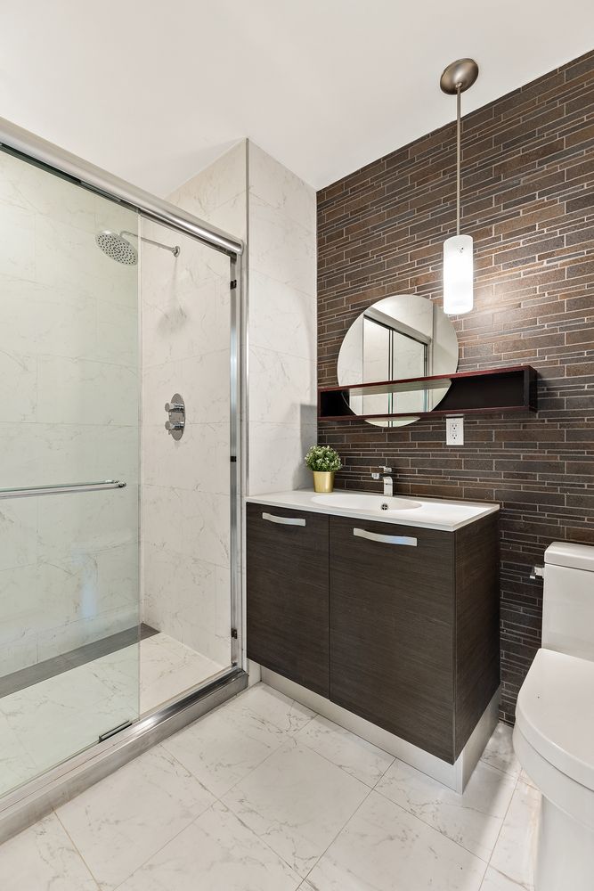 1638 8th Avenue, Unit 1B Brooklyn, NY 11215 - Photo 4 of 12 a bathroom with a sink a toilet and shower