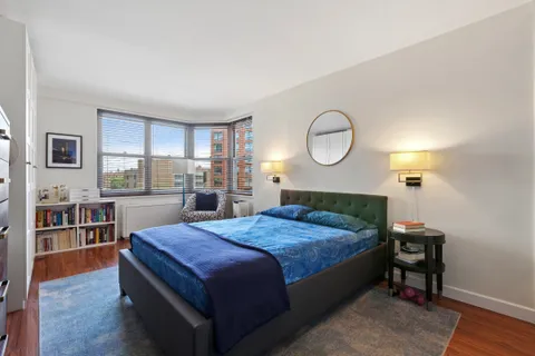 a bedroom with a bed and a cabinets