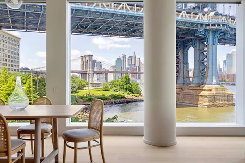 a dining room with furniture and a window