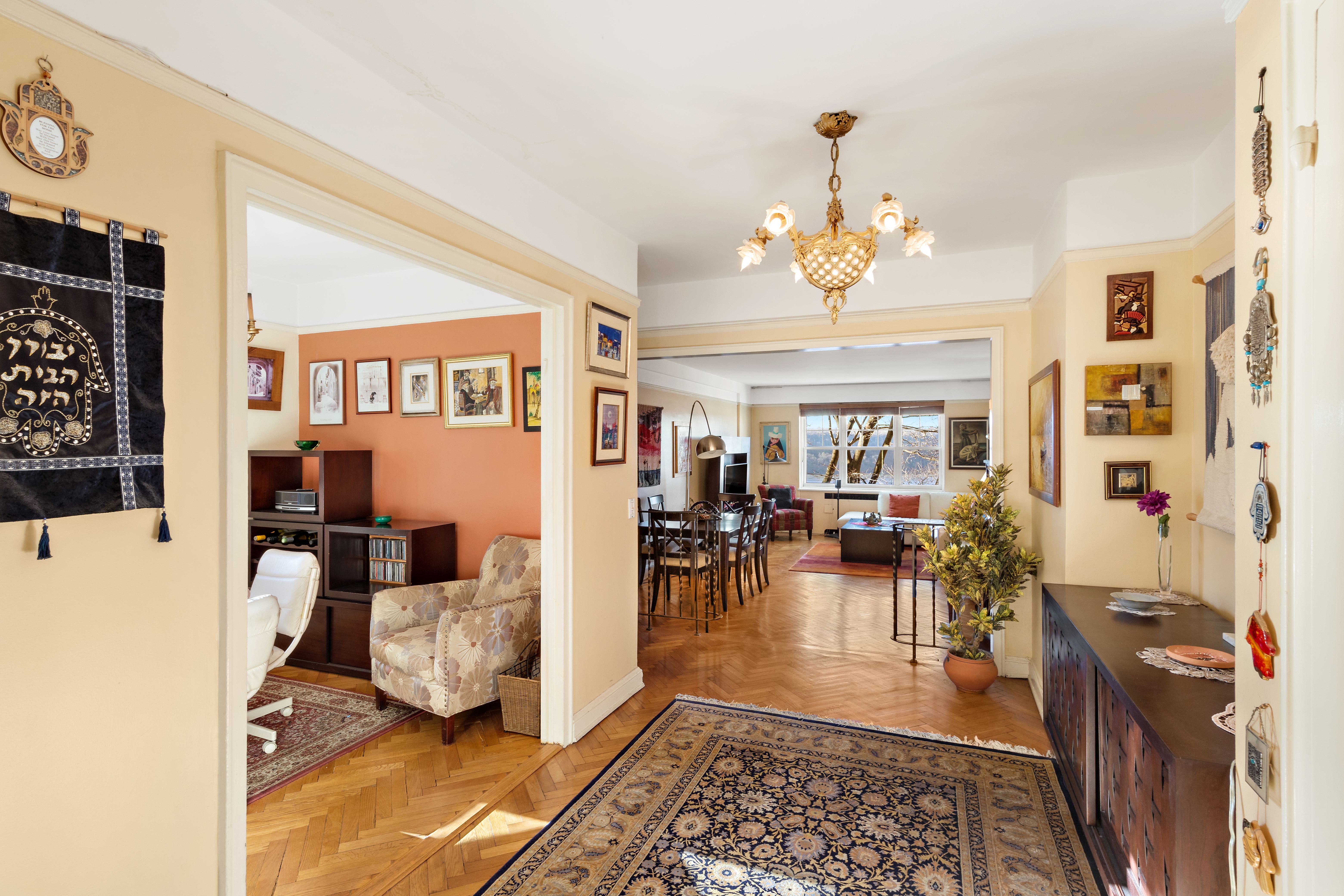160 Cabrini Boulevard, Unit 19 Manhattan, NY 10033 - Photo 1 of 27 a living room with furniture and a chandelier