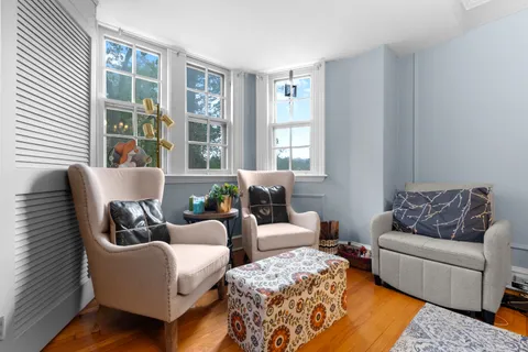 a living room with furniture and a large window