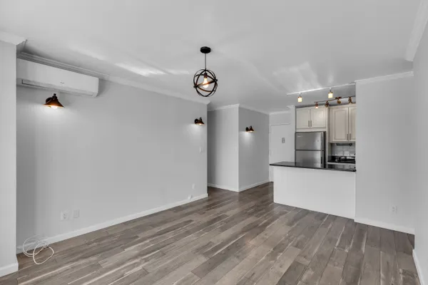 a kitchen with stainless steel appliances granite countertop a refrigerator a stove and a sink