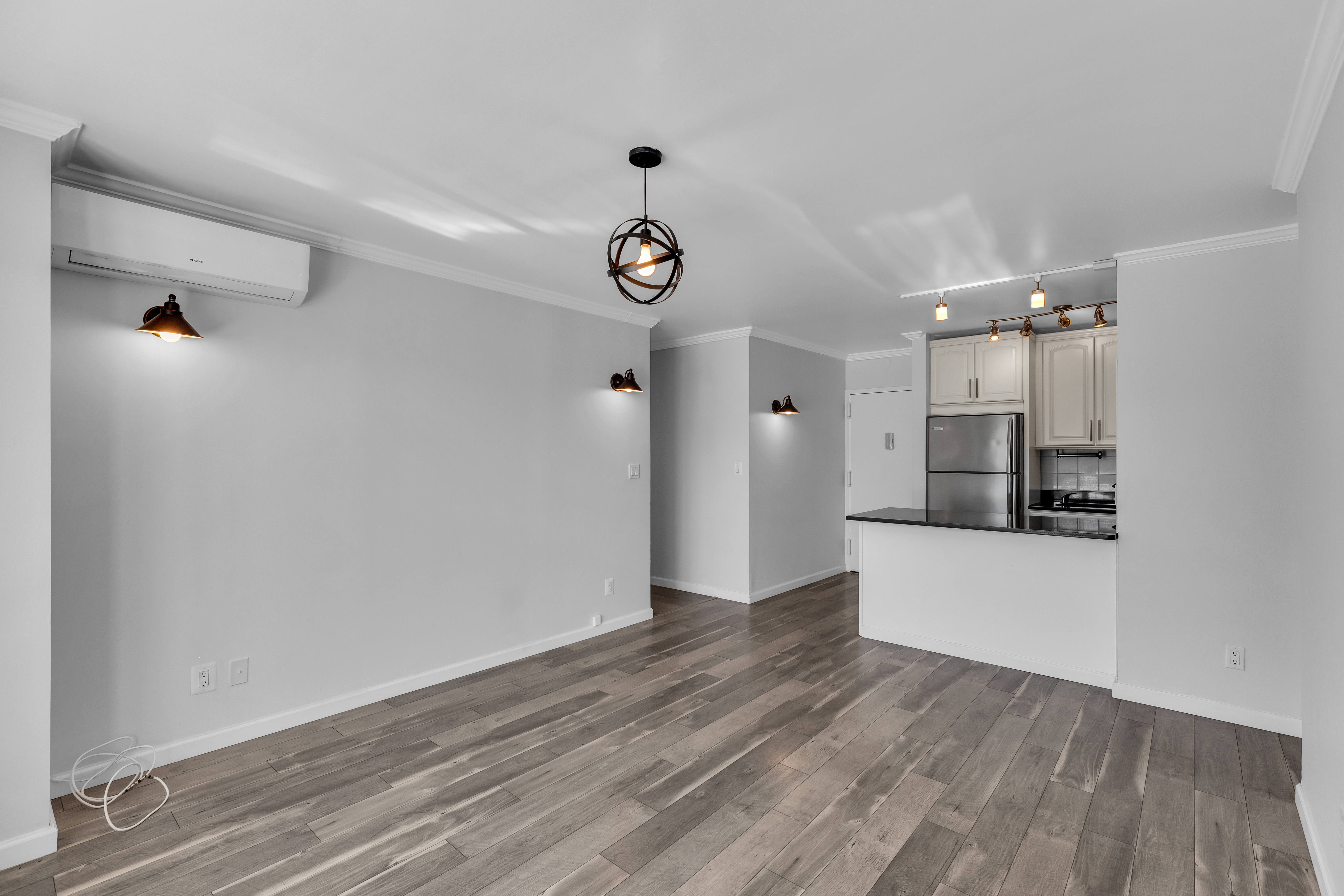 25-40 Shore Boulevard, Unit 2F Queens, NY 11102 - Photo 7 of 31 a view of a kitchen with wooden floor and a sink