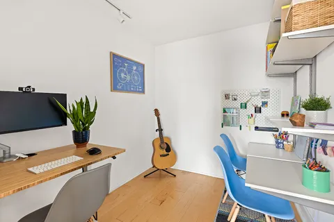 a dining room with furniture a potted plant and a table