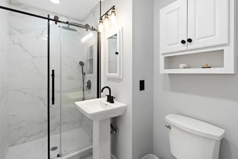 a bathroom with a sink toilet and shower