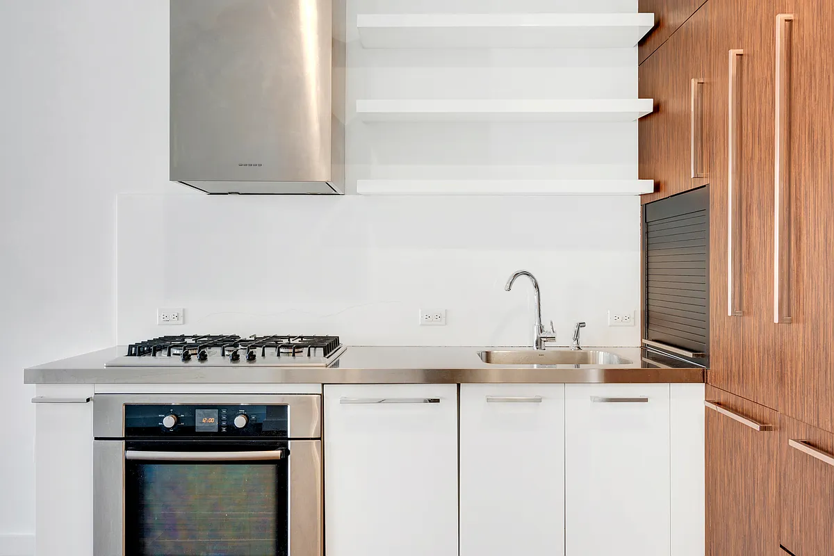 133 West 22nd Street, Unit 6A Manhattan, NY 10011 - Photo 3 of 9 a kitchen with a stove and cabinets