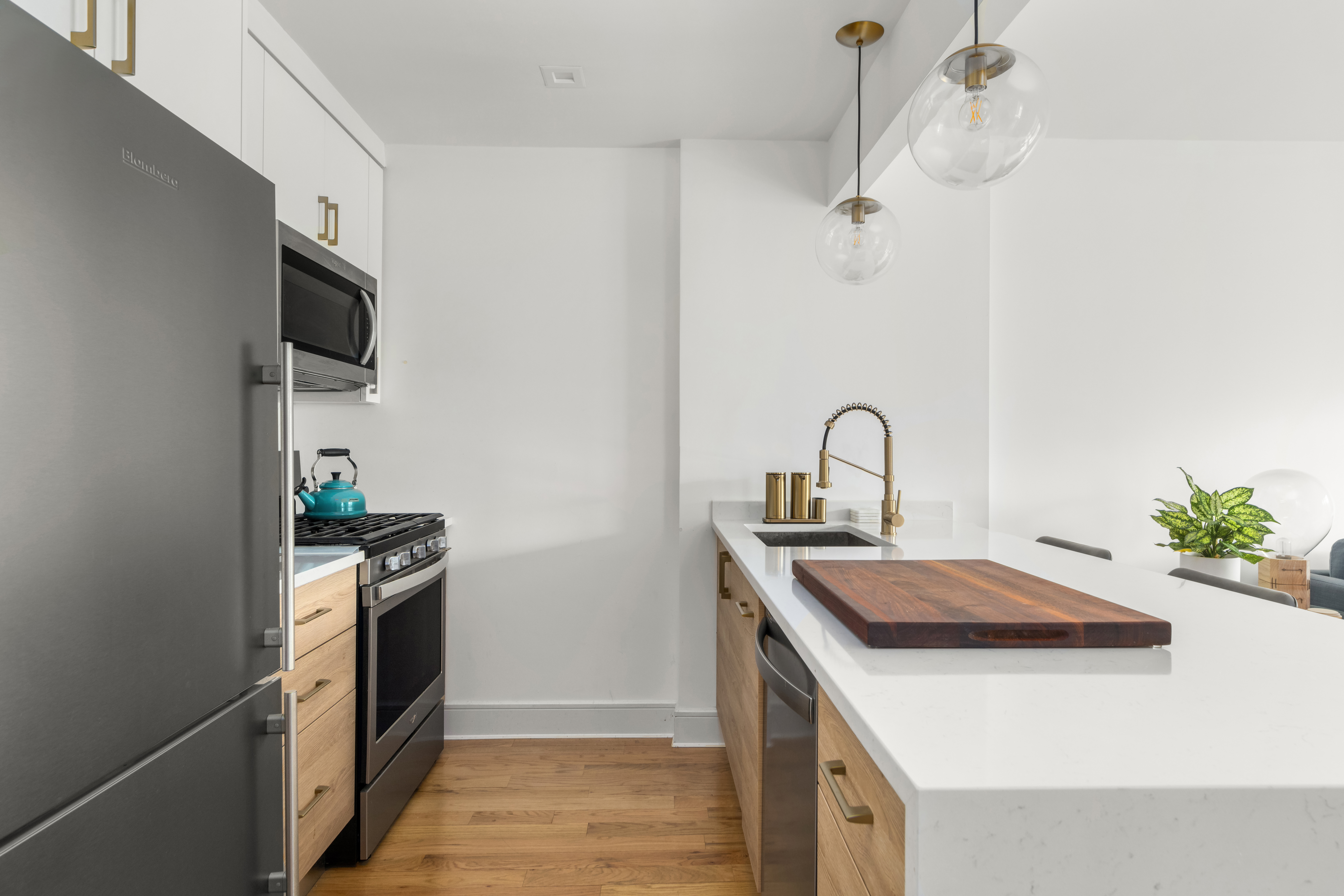 1021 Bedford Avenue, Unit 403 Brooklyn, NY 11205 - Photo 3 of 13 a kitchen with a sink and stainless steel appliances