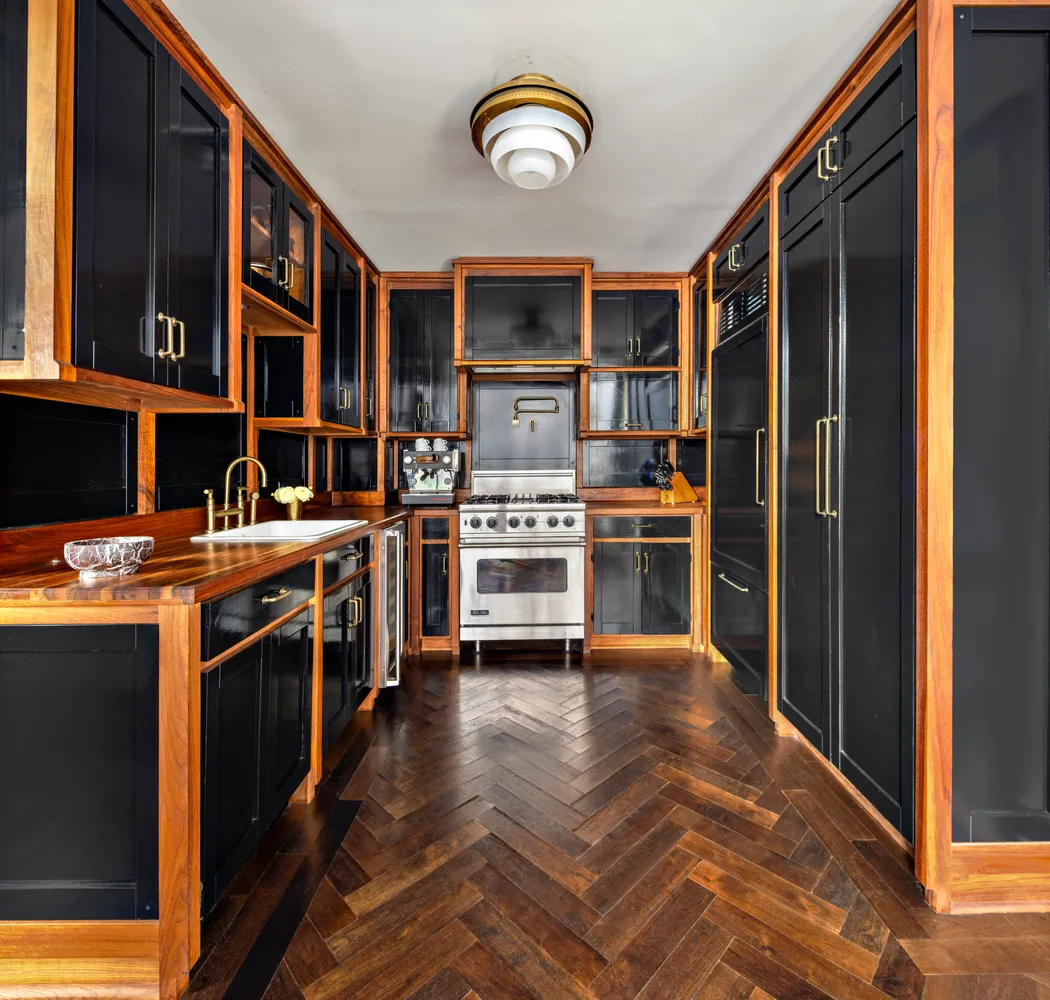 a view of a kitchen with a stove top oven and cabinets