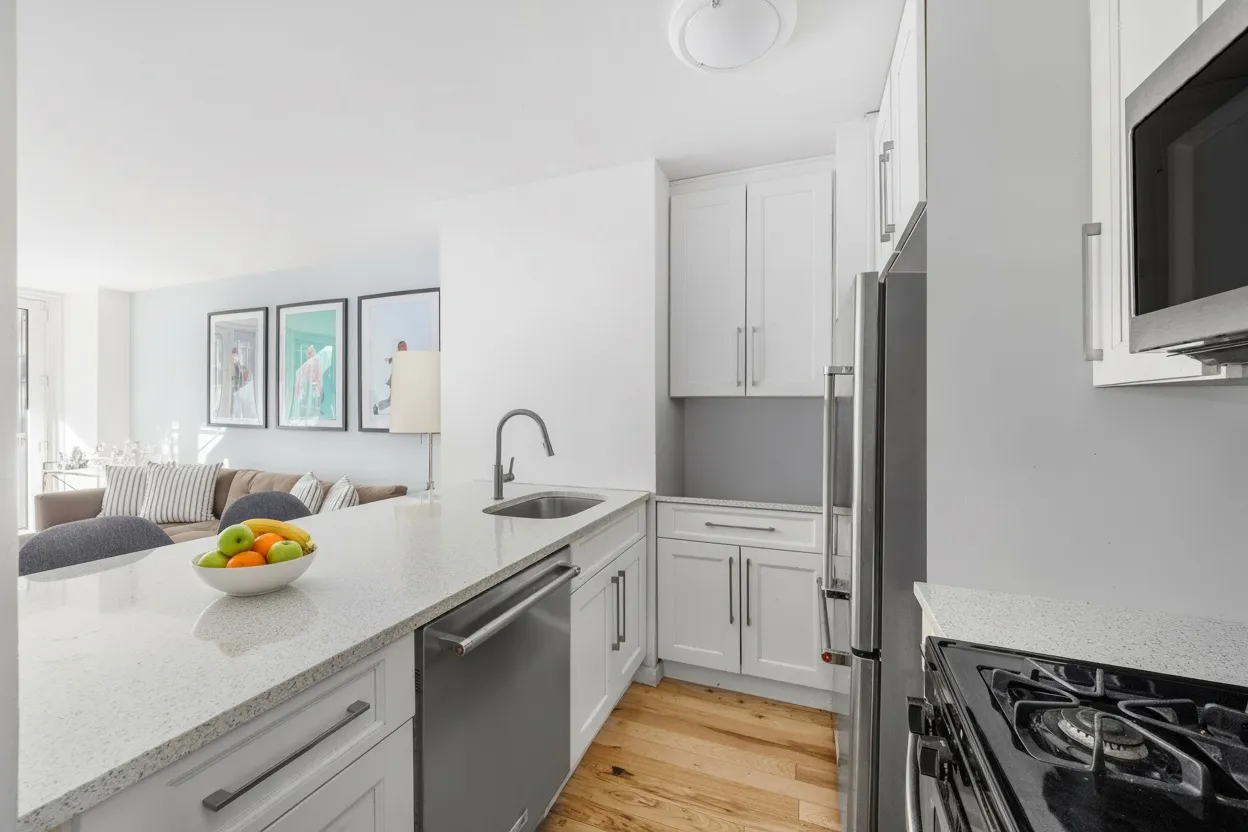 a kitchen with stainless steel appliances a sink a stove and a refrigerator