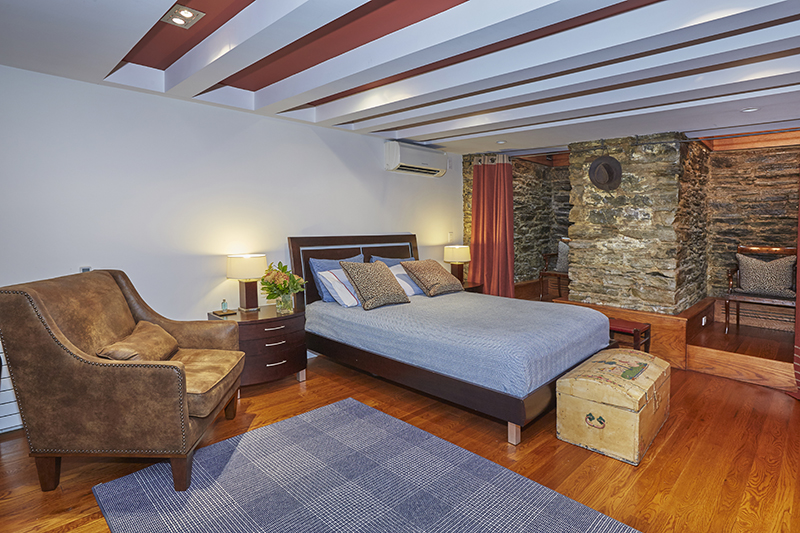 308 West 19th Street, Unit GARDEN Manhattan, NY 10011 - Photo 13 of 18 a bedroom with a bed and wooden floor