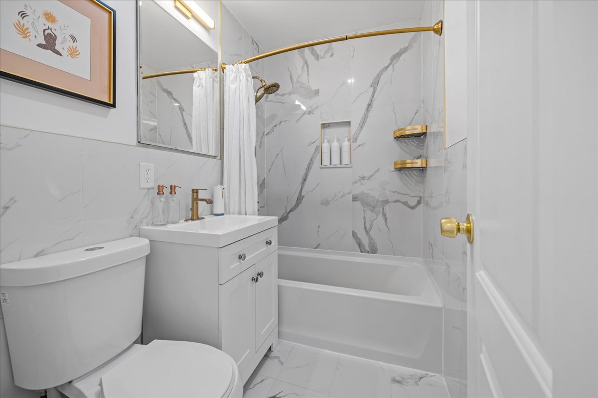 759 East 10th Street, Unit 7H Brooklyn, NY 11230 - Photo 11 of 15 a bathroom with a sink a toilet and a bathtub