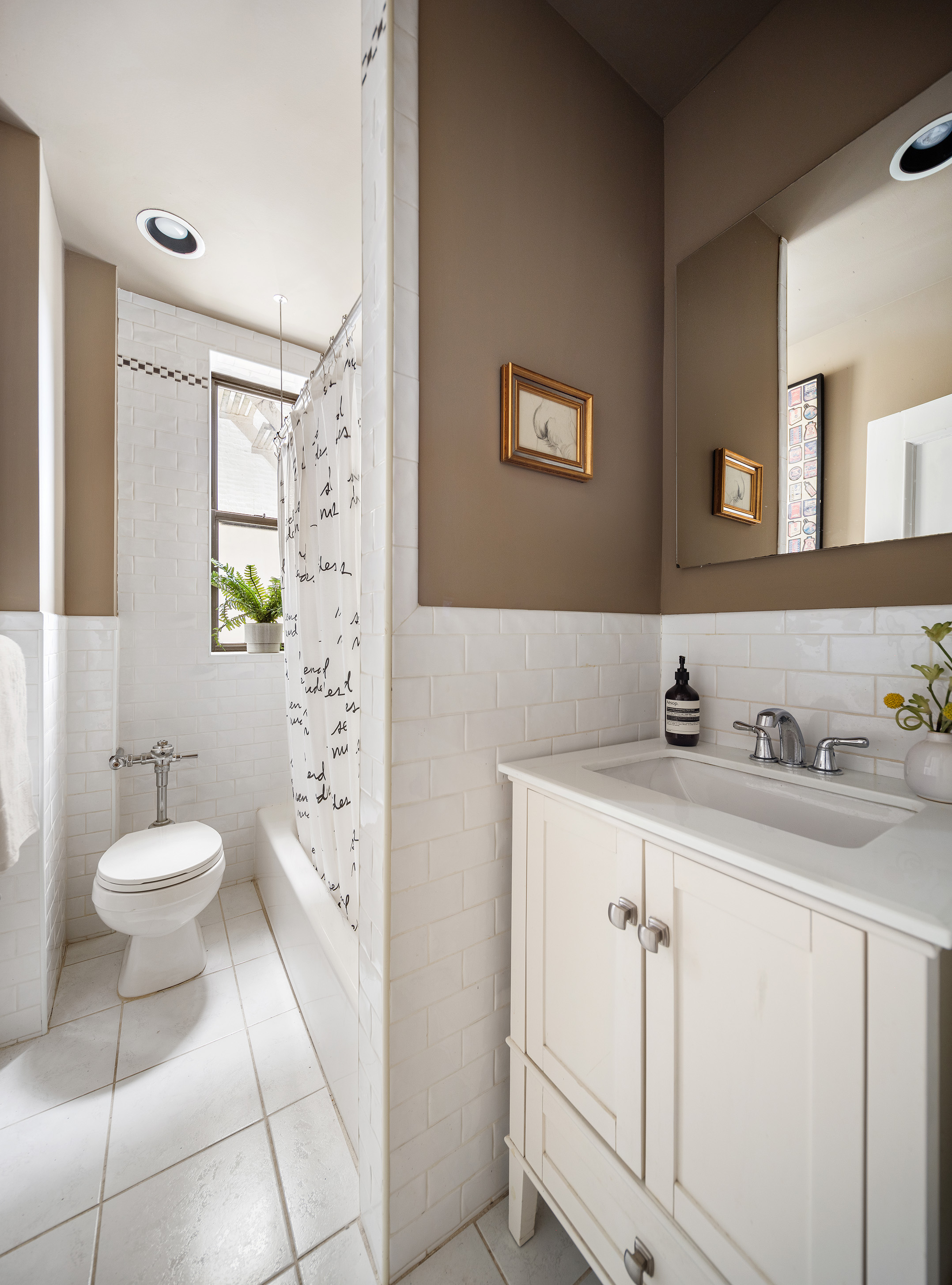 125 Prospect Park West, Unit 2E Brooklyn, NY 11215 - Photo 11 of 14 a bathroom with a sink a toilet and a mirror