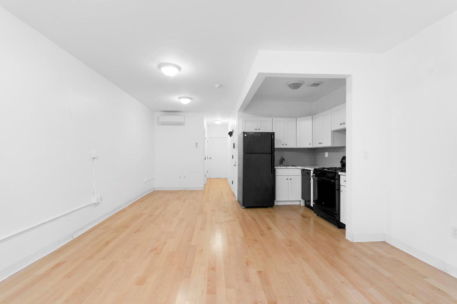 251 Powers Street Brooklyn, NY 11211 - Photo 5 of 11 a view of kitchen with wooden floor