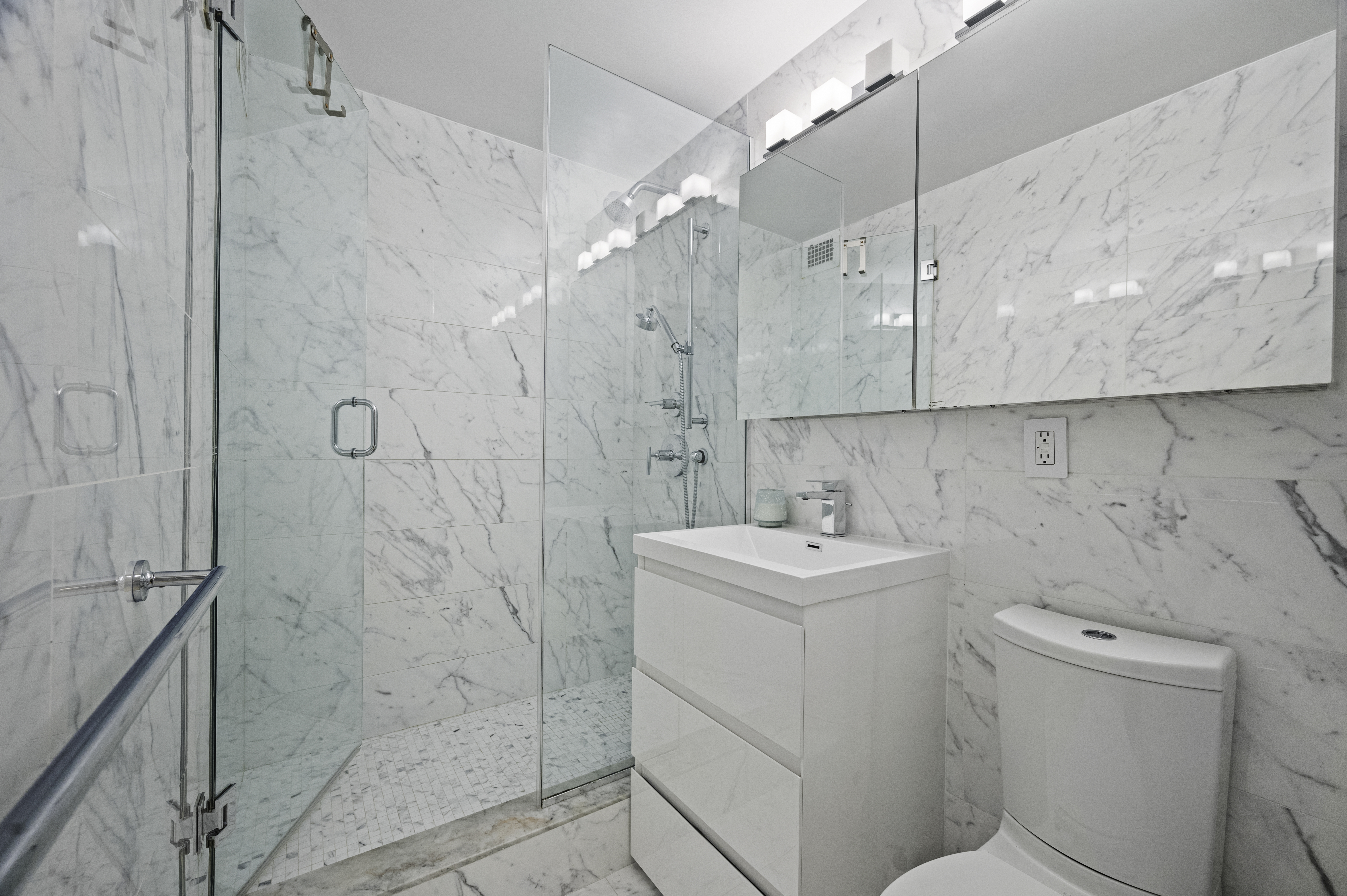 301 East 62nd Street, Unit 7K Manhattan, NY 10065 - Photo 8 of 14 a bathroom with a sink a toilet and shower