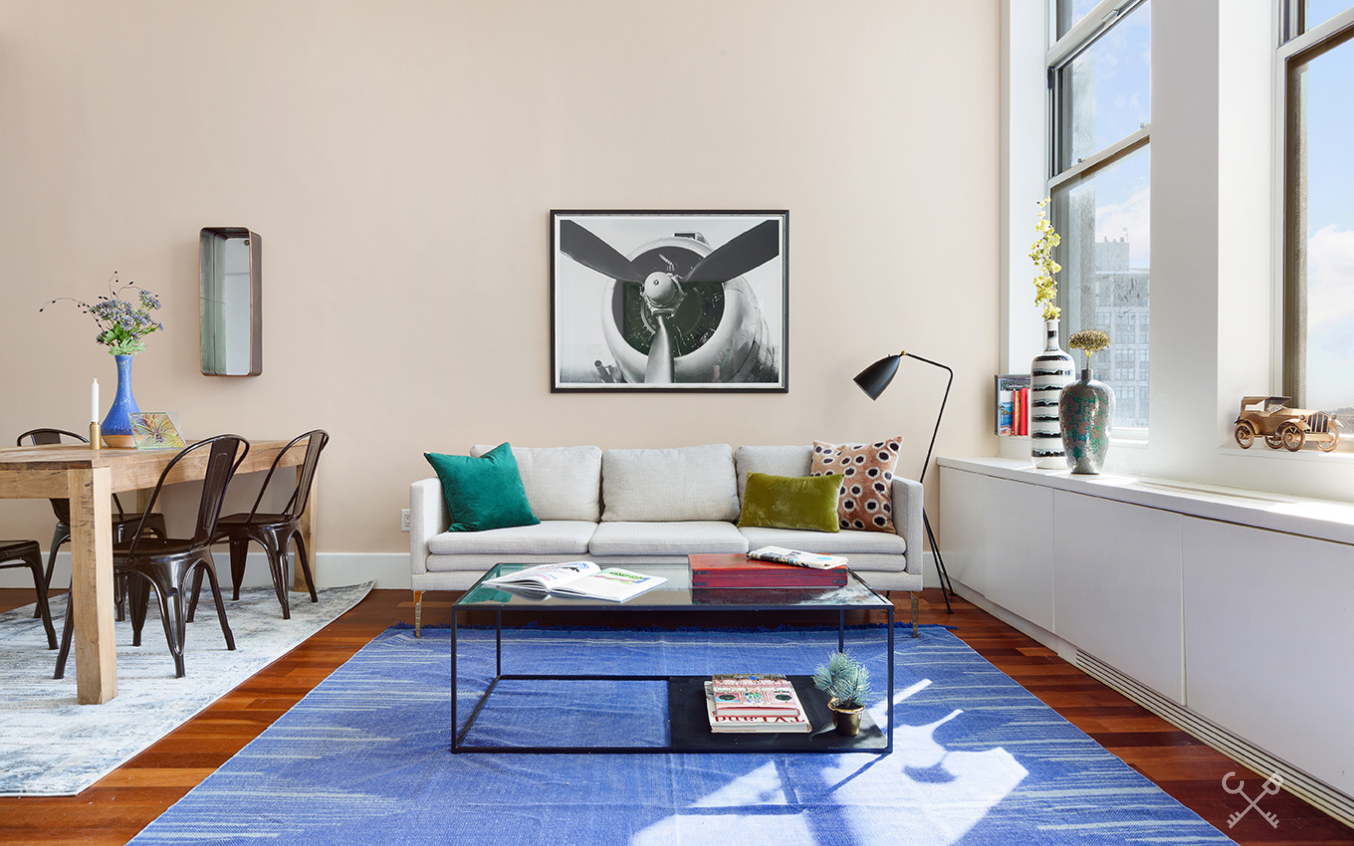 60 Broadway, Unit 10M Brooklyn, NY 11249 - Photo 2 of 12 a living room with furniture and a wooden floor