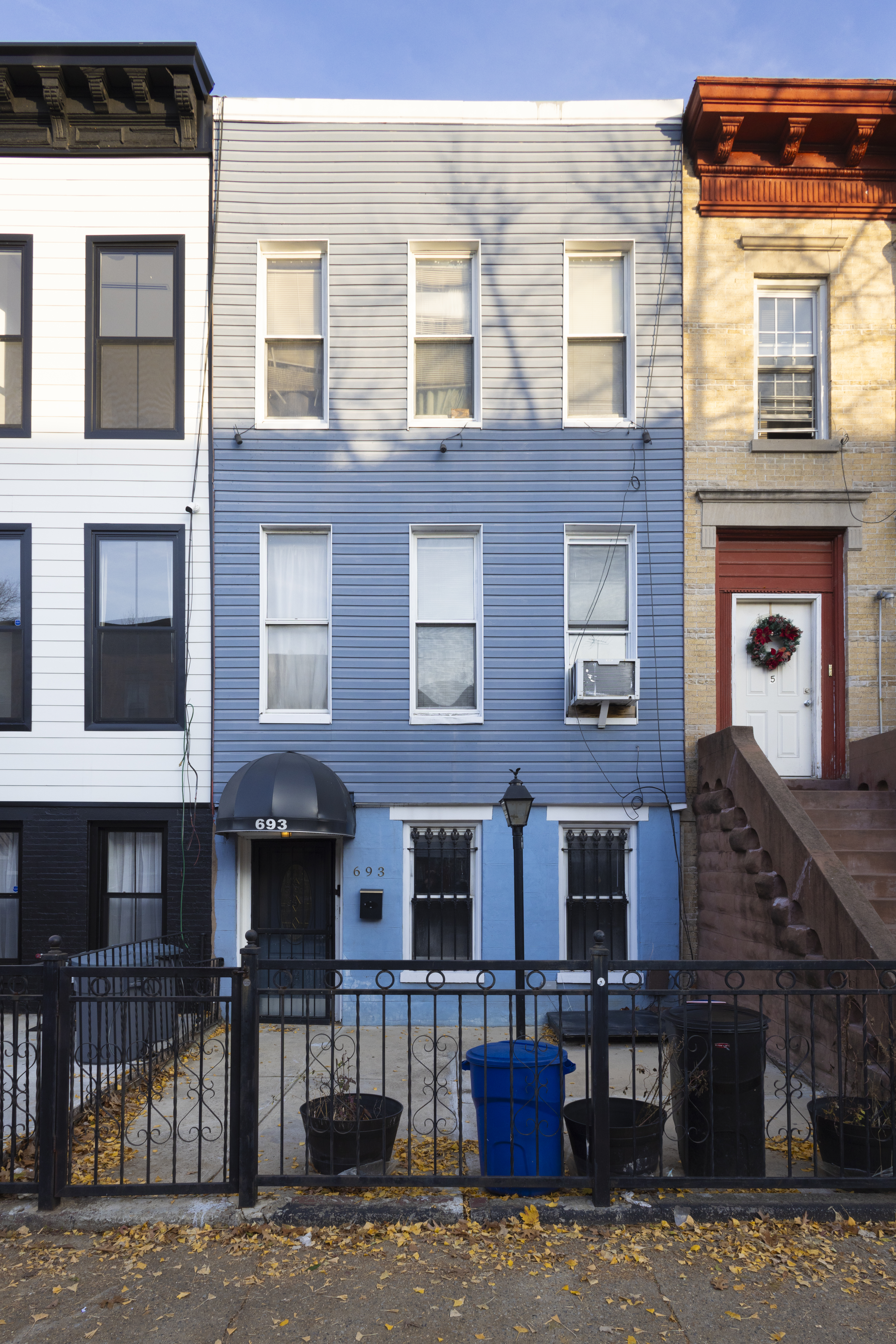 693 MacDonough Street, Unit 2A Brooklyn, NY 11233 - Photo 10 of 11 a front view of a house with barbeque and parking