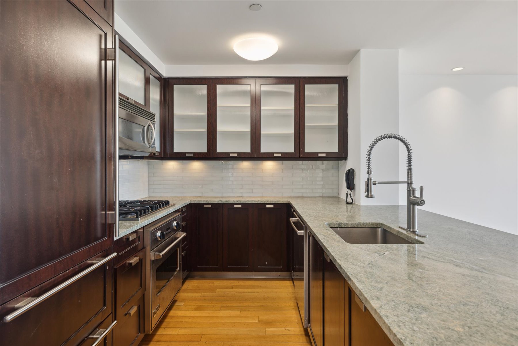 80 Riverside Boulevard, Unit 4X Manhattan, NY 10069 - Photo 3 of 19 a kitchen with a granite countertop sink a stove and a window