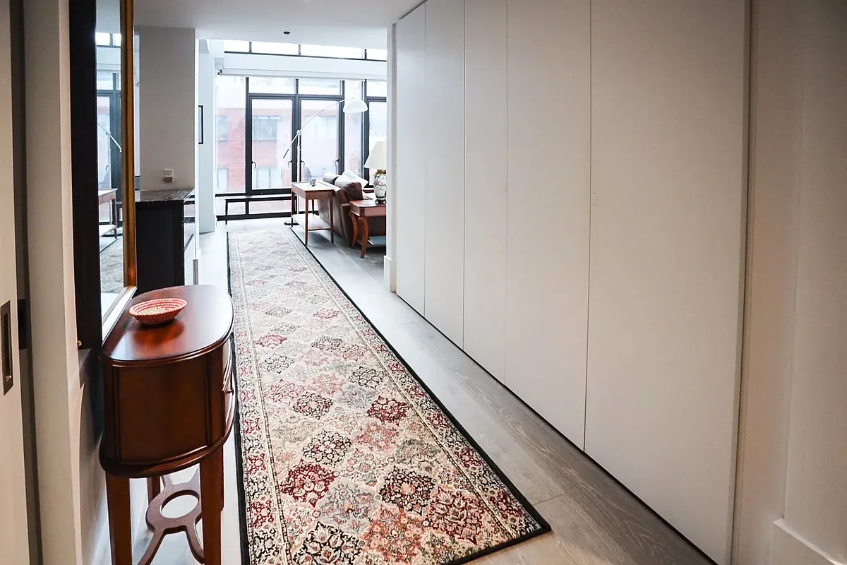 wooden floor with a view of living room