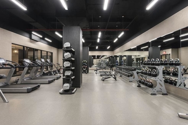 100 Barclay Street, Unit 15P Manhattan, NY 10007 - Photo 26 of 34 a view of a room with gym equipment