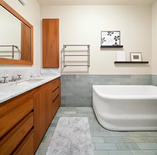 a bathroom with a tub sink and mirror
