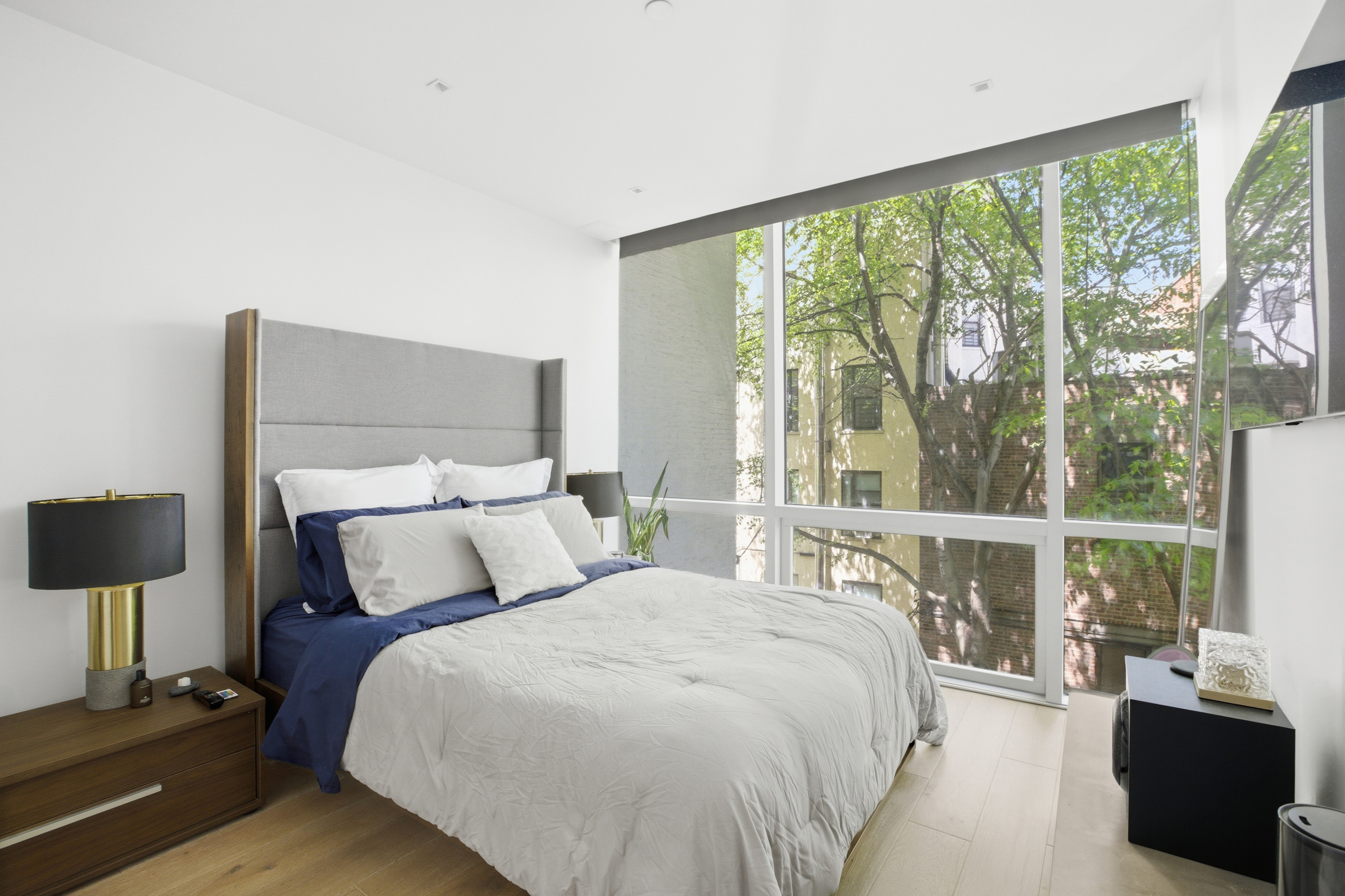 313 West 121st Street, Unit 2 Manhattan, NY 10027 - Photo 5 of 12 a bedroom with a bed and a large window