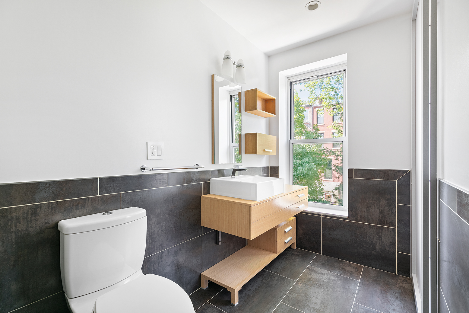 428 5th Street Brooklyn, NY 11215 - Photo 15 of 26 a bathroom with a toilet a sink and a mirror
